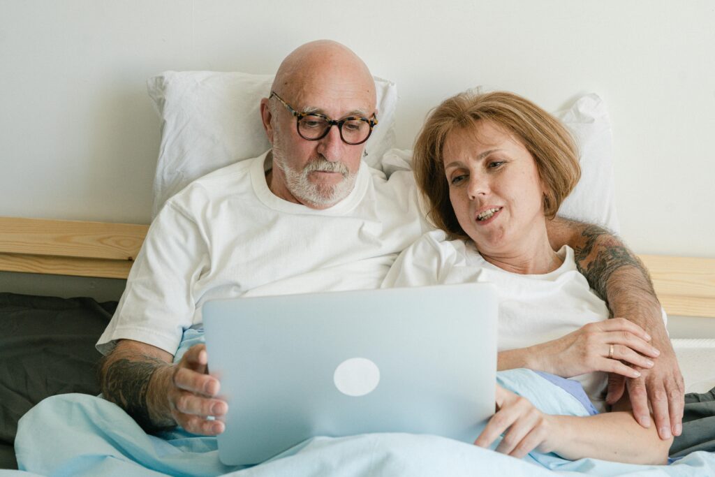 Elderly Couple Looking at the Screen of a Laptop